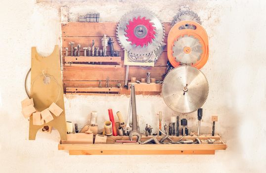 hanging workbench with cutting discs, drills and tools, white background