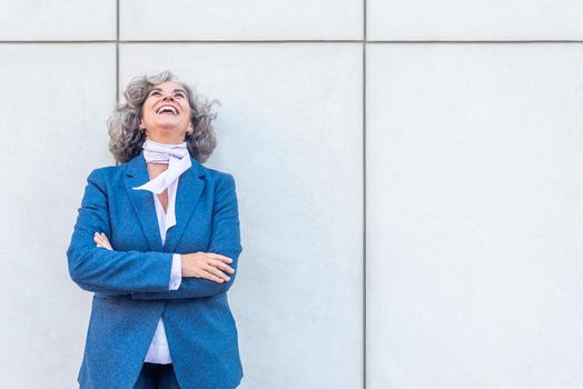 entrepreneur laughing out loud with her arms folded. Copy space on the right