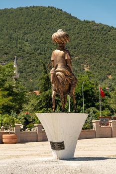 Aksehir, Turkey - July 04, 2022: The modern monument of the national hero Hoca Nasreddin and Aksehir city square