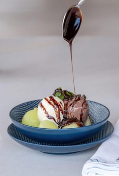 Fruit ice cream on melon balls on marble table