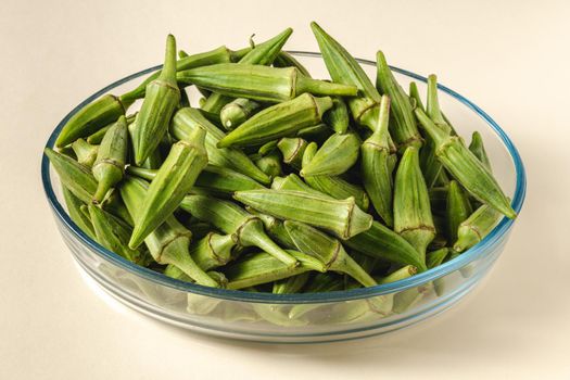 Fresh raw okra in a glass bowl. Healthy eating concept