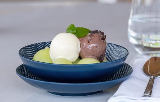 Fruit ice cream on melon balls on marble table