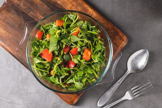 Purslane salad with tomatoes in a glass bowl. Healthy eating concept