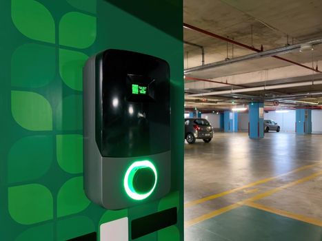 Electric car charging station in the indoor parking lot of the shopping mall