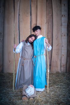 Vertical photo of Lgtb version of a nativity scene with men representing Virgin Mary and Joseph