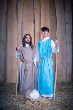 Vertical photo of a lgtb nativity scene with a gay couple as main characters