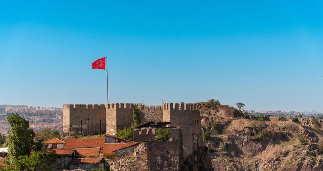 Ankara Castle with the Turkish flag flying over it. Turkish name is Ankara Kalesi