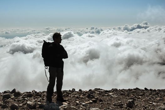 Adult caucasian male in sportswear standing on the summit of a mountain peak. Lost mountain in Spain