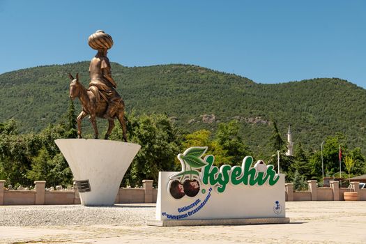 Akşehir, Turkey - July 04, 2022: The modern monument of the national hero Hoca Nasreddin and Aksehir city square