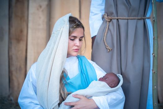 Caucasian virgin mary holding a black baby representing Jesus