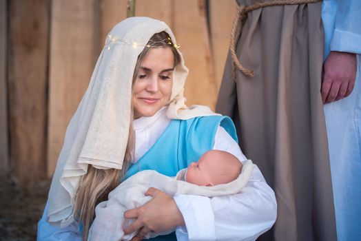 Close up view of virgin mary holding Jesus baby in a traditional nativity scene in a crib