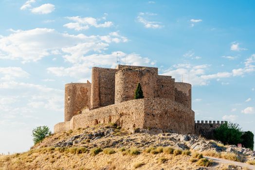 Restored medieval castle and walls on a hill in a sunny day Consuegra, Toledo, Spain