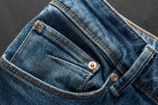 Ecological blue jeans on dark background. Eco friendly clothing concept