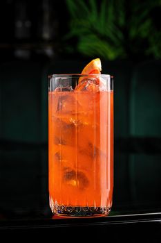 Refreshing citrus and alcoholic cocktail on dark background