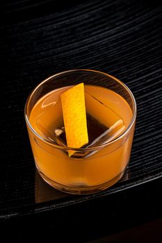 Refreshing citrus and alcoholic cocktail on dark background