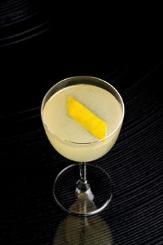 Iced yellow lemon and citrus cocktail with lemon zest
