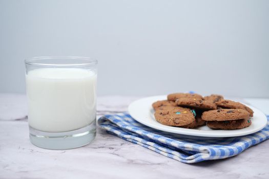 glass of milk and cookies on table