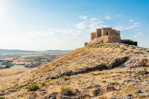 Photo with copy space of a medieval fortified castle with a village on the background in Consuegra, Toledo, Spain