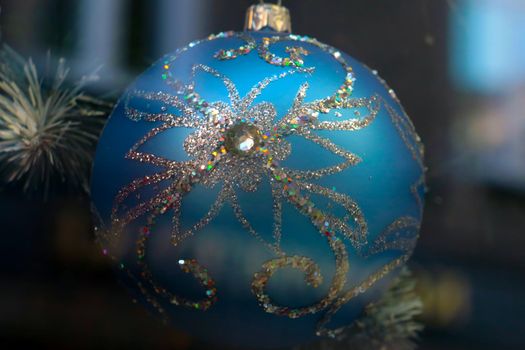 Beautiful bright blue ball on a Christmas tree. The advent of the New Year