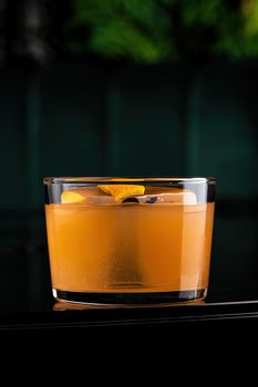 Refreshing citrus and alcoholic cocktail on dark background