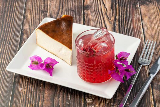 Strawberry tea and san sebastian cheesecake on wooden table