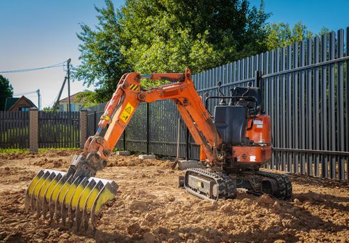 Minitractor on a working agricultural plot. Land works