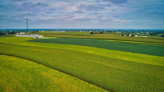 Drone View of Amish Countryside With Barns and Silos and Corn, Patch Work of Color and Corps, on Sunny Day.