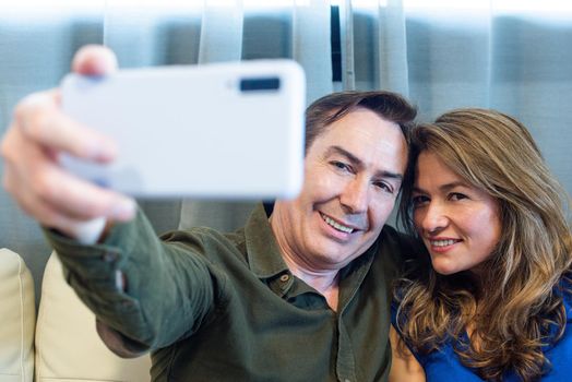 Smiling mature man and woman taking a selfie. High quality photo