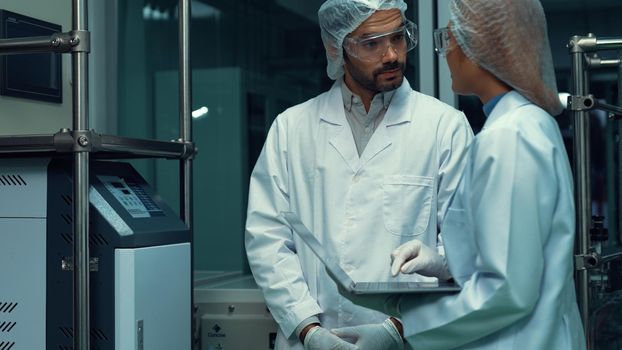 Two scientist in professional uniform working in laboratory for chemical and biomedical experiment