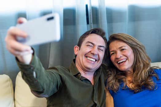 Smiling mature man and woman taking a selfie. High quality photo