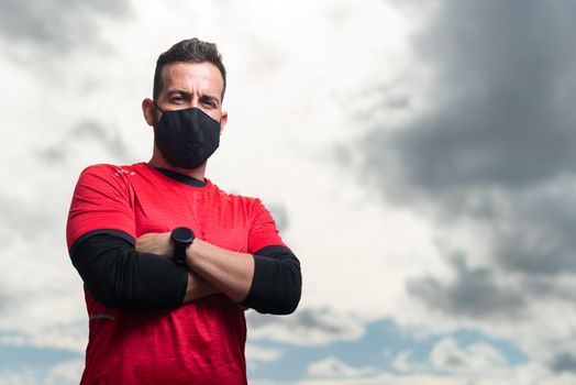 Sportsman with mask looking at camera seriously. High quality photo