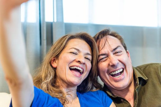 Smiling mature man and woman taking a selfie. High quality photo