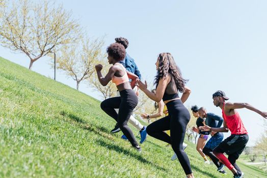 Group of runners running up a hill. Horizontal framing.