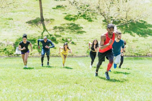 Group of runners running up a hill. Horizontal framing.