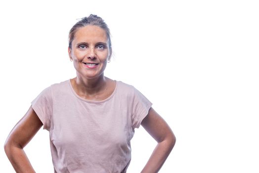 Front view of a green-eyed woman with her hands on her waist looking at camera on a white background with copy space.