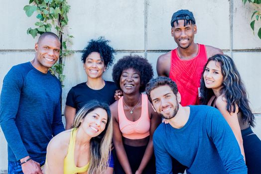 Portrait of a group of runners smiling at camera. Horizontal framing.