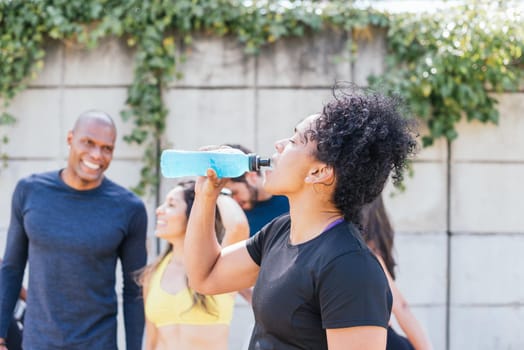 Runner woman drinking after a race. Horizontal framing.