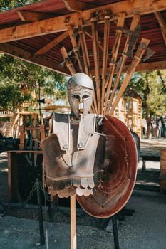 Exhibition of knightly armor in ancient fortress. Swords, shields and other weapons. High quality photo