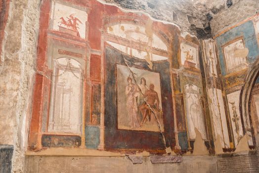 Paintings on the walls at the seat of the Augustan priests at the Roman archaeological site of Herculaneum, Italy.