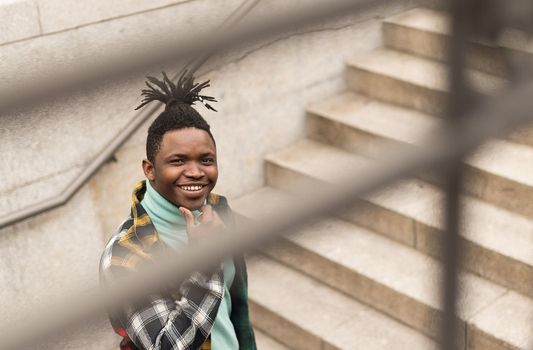 Black man on a stairs in the city. Selective focus.