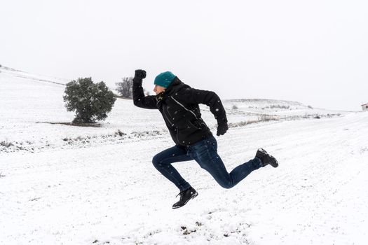 Side view of person running in a snowy landscape. Madrid. Spain
