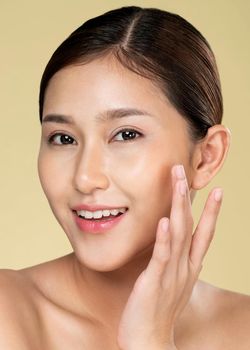 Closeup ardent young woman with healthy clear skin and soft makeup looking at camera and posing beauty gesture. Cosmetology skincare and beauty concept.