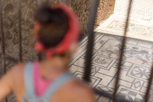 Woman watching the Roman archaeological site of Pompeii, in Italy.