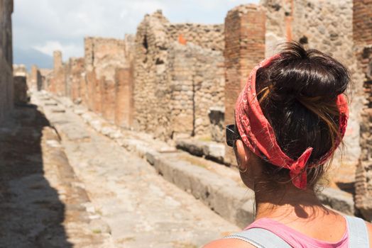 Woman watching the Roman archaeological site of Pompeii, in Italy.