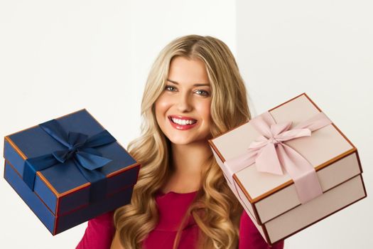 Happy woman holding gifts for birthday, anniversary, wedding, Valentines day or Christmas, luxury holiday present or beauty box subscription delivery concept