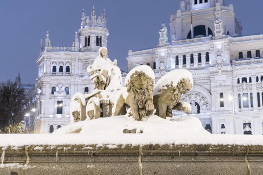 Plaza de la Cibeles in Madrid on a cold winter night after a heavy snowfall.