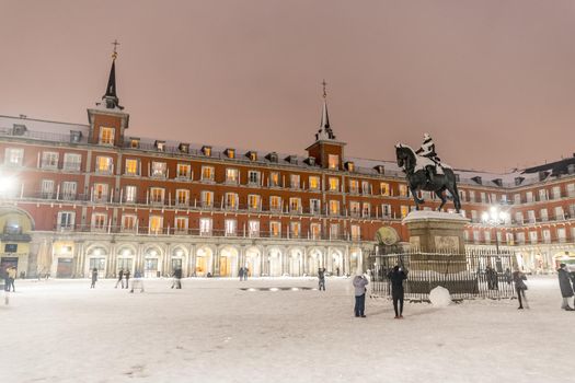 Plaza Mayor in Madrid on a cold winter night after a heavy snowfall.