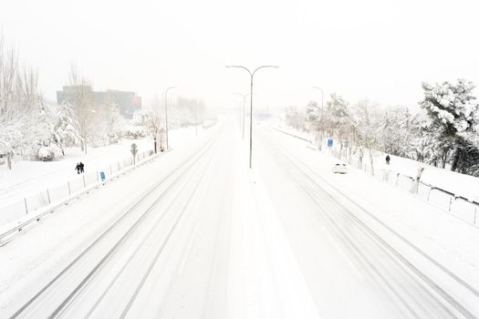 Snow covered highway on a cold winter day after a heavy snowfall. Madrid. A-2. Spain.