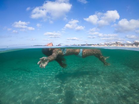 Woman floating face up in sea water, very relaxed. Formentera island. Spain.