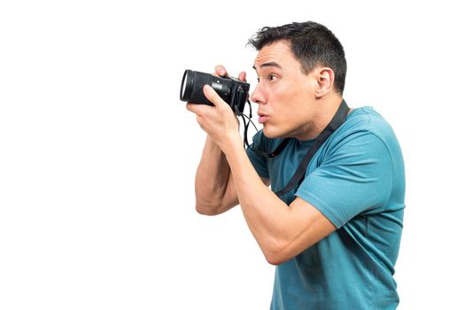 Side view of attentive male photographer taking photo on camera on white isolated background